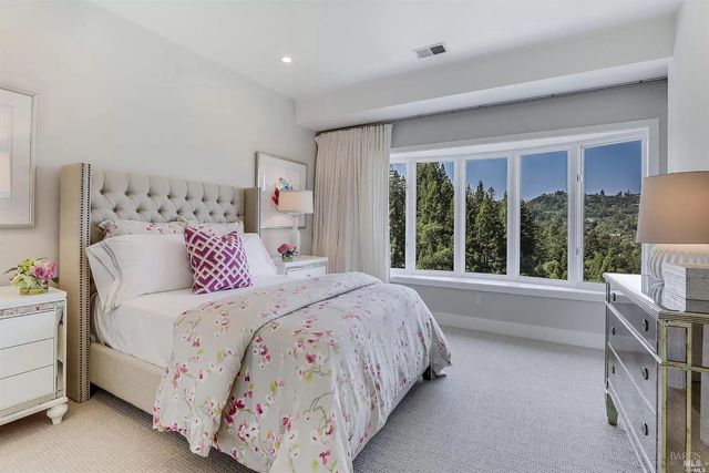 a bedroom with a large bed and a large window