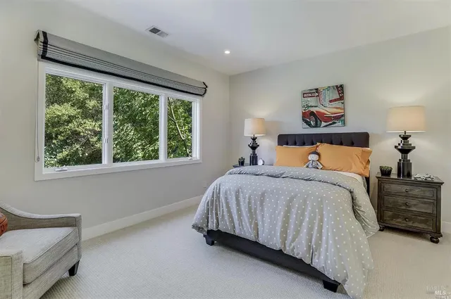 a bedroom with a bed and window