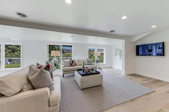 a living room with furniture and a large window