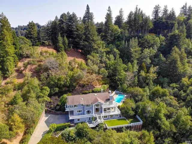 an aerial view of a house with a yard