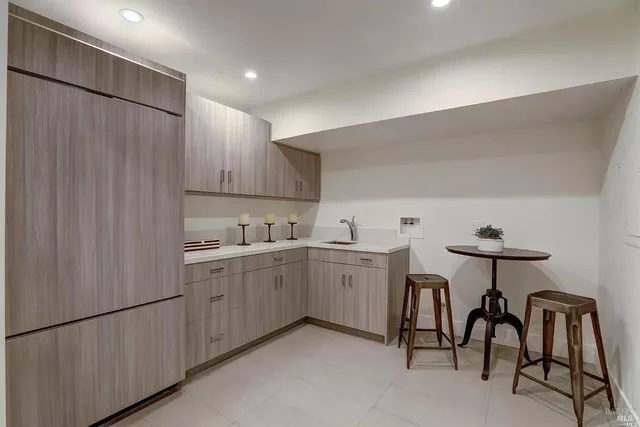 a kitchen with cabinets and chairs