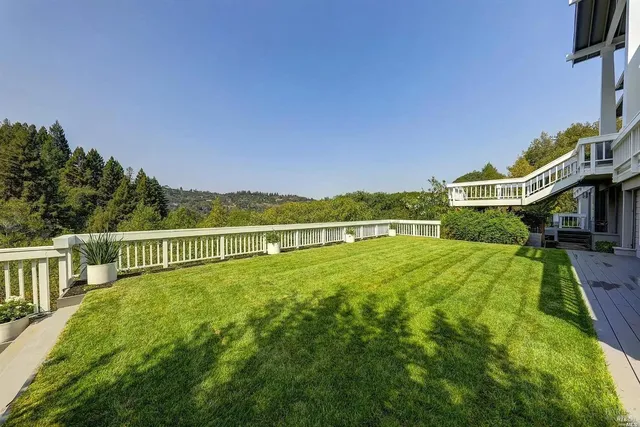 a view of an house with swimming pool and deck