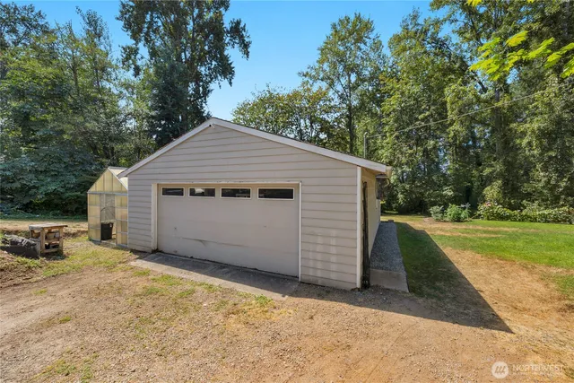 a front view of house with yard and trees in the background