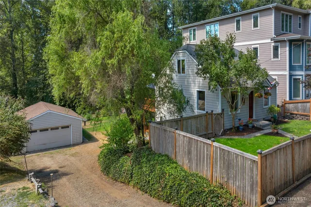 front view of house with deck and yard