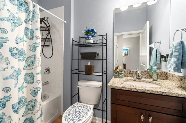 a view of a kitchen from the hallway with a wooden floor