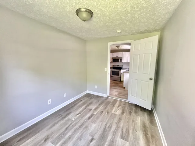 a view of a room with wooden floor