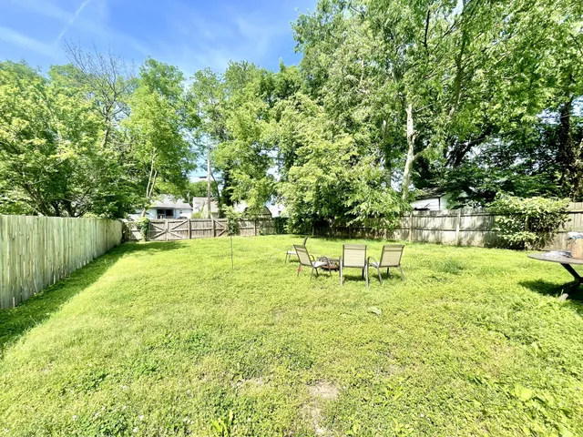 a view of a chair and table in the garden