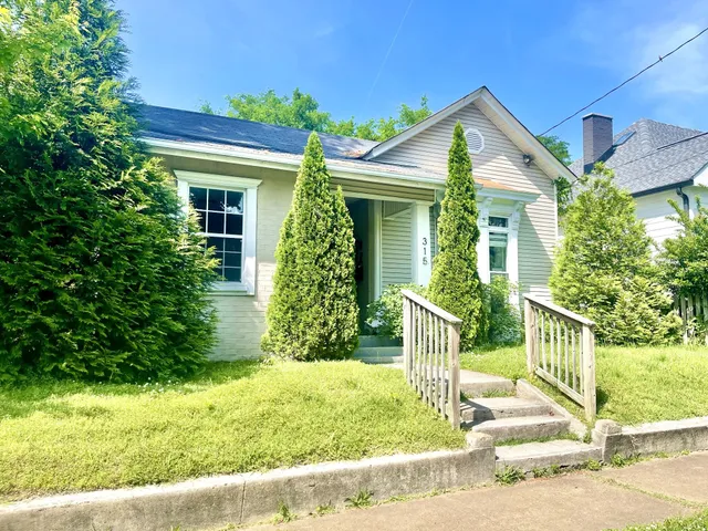 a front view of house with green space