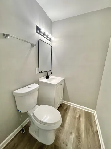 a bathroom with a toilet a sink and mirror