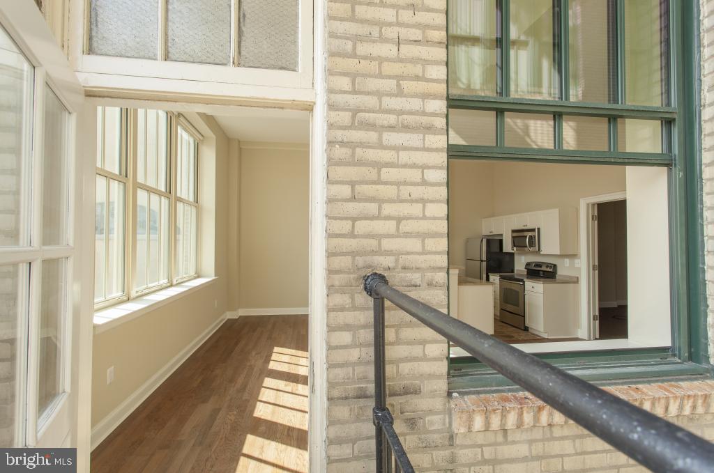312-22 Walnut Street, Unit 109 Philadelphia, PA 19106 - Photo 2 of 18 a view of a balcony with wooden floor and staircase