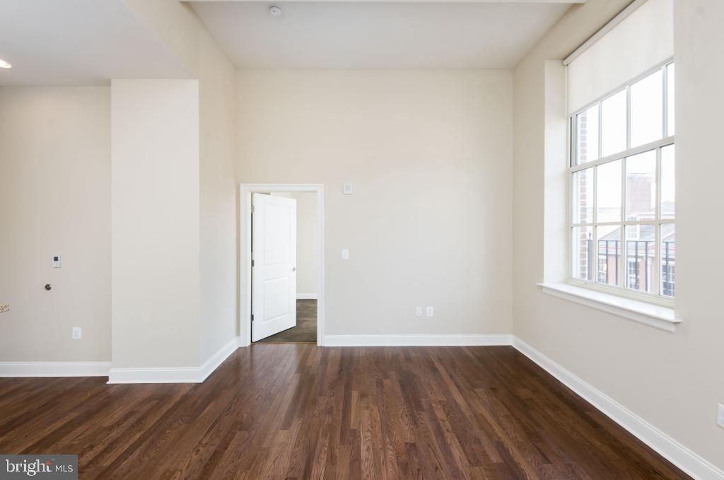 312-22 Walnut Street, Unit 109 Philadelphia, PA 19106 - Photo 7 of 18 an empty room with wooden floor and windows