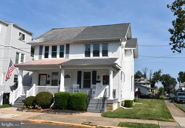 a front view of a house with garden and plants