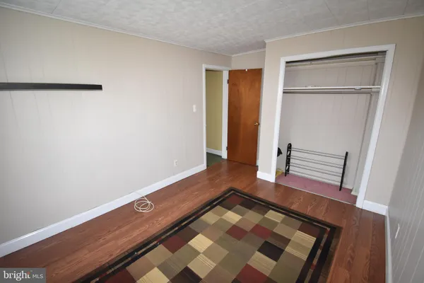 a view of room with wooden floor