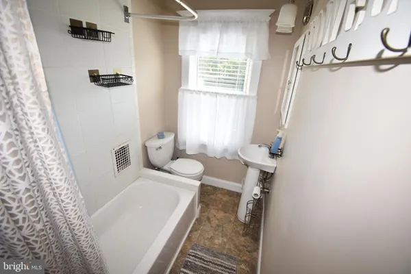a bathroom with a bathtub and shower