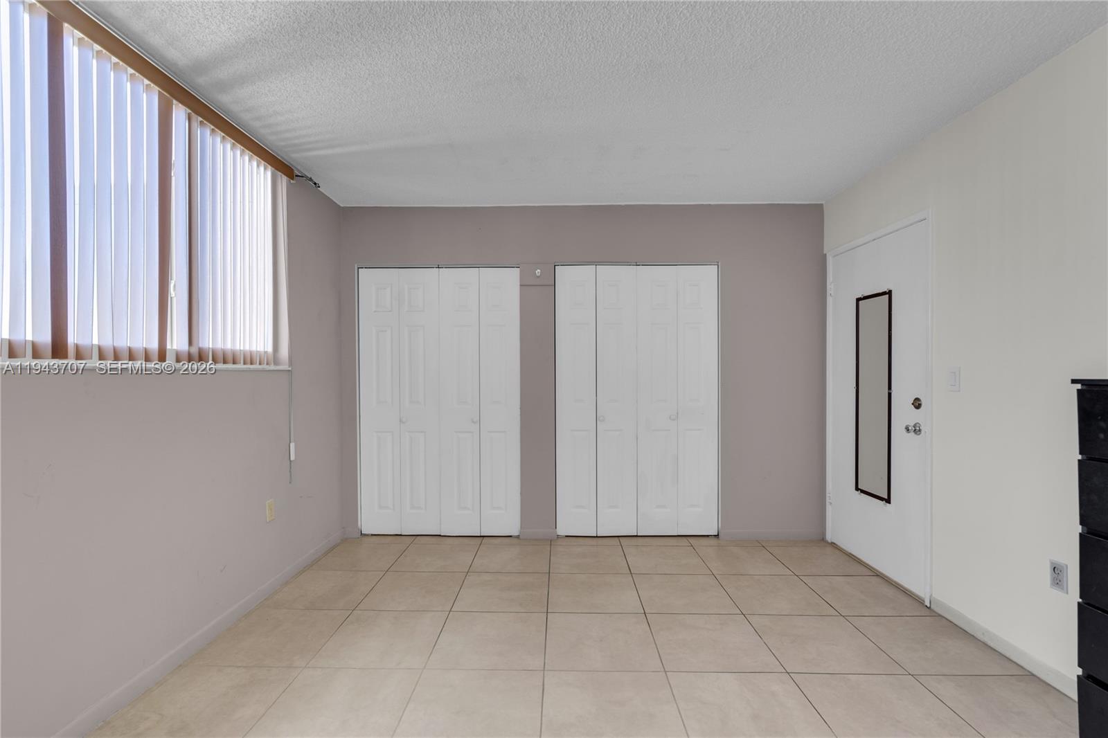 8050 Northwest 8th Street, Unit 305 Miami, FL 33126 - Photo 11 of 25 an empty room with windows