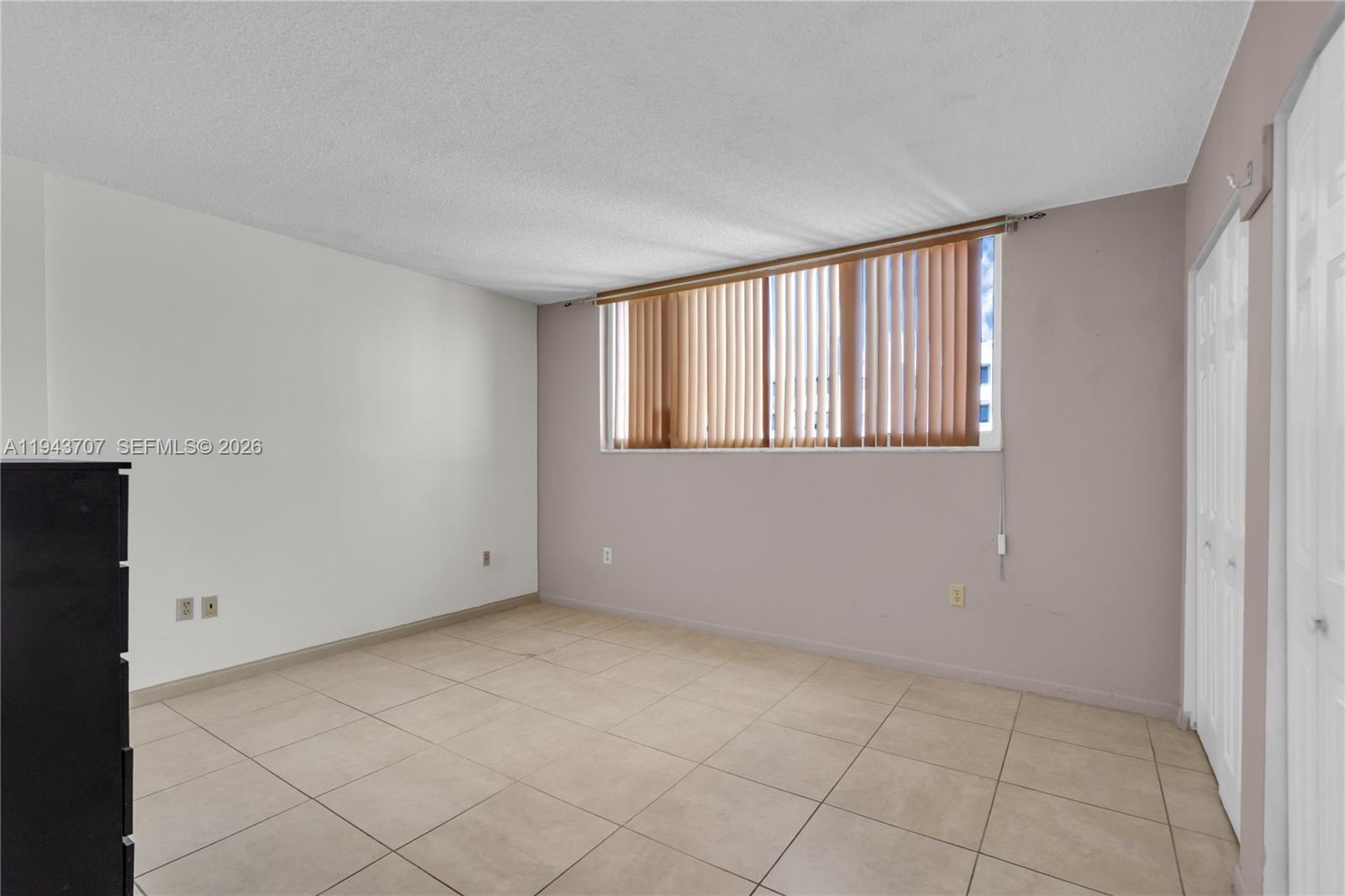 8050 Northwest 8th Street, Unit 305 Miami, FL 33126 - Photo 13 of 25 a view of an empty room with a window