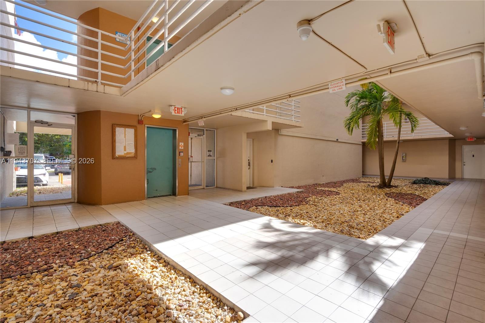 8050 Northwest 8th Street, Unit 305 Miami, FL 33126 - Photo 18 of 25 a view of a hallway with a outdoor space