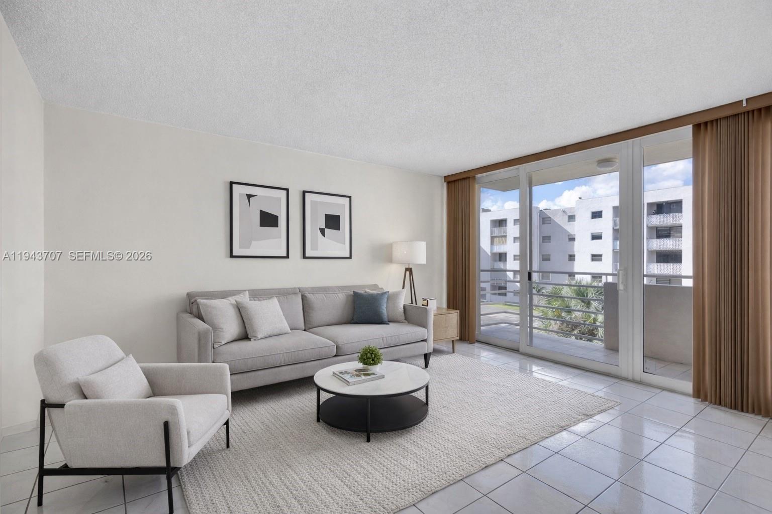 8050 Northwest 8th Street, Unit 305 Miami, FL 33126 - Photo 2 of 25 a living room with furniture and a large window