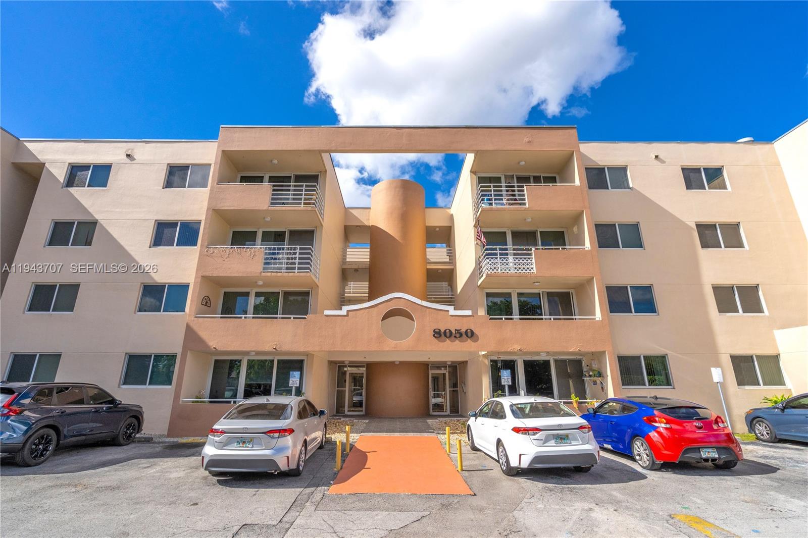8050 Northwest 8th Street, Unit 305 Miami, FL 33126 - Photo 21 of 25 a front view of a building with parking space