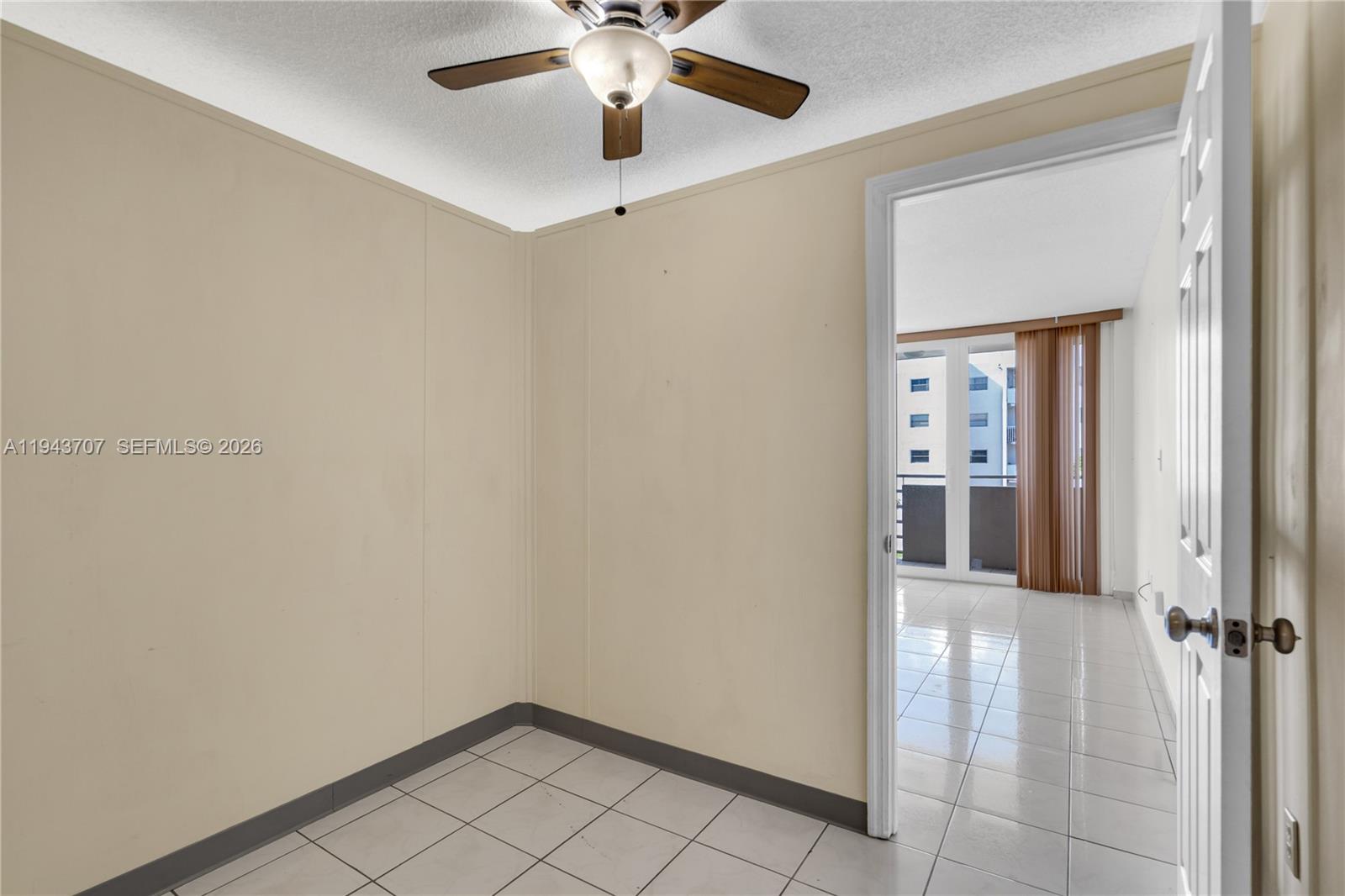 8050 Northwest 8th Street, Unit 305 Miami, FL 33126 - Photo 8 of 25 a view of a hallway with a chandelier fan