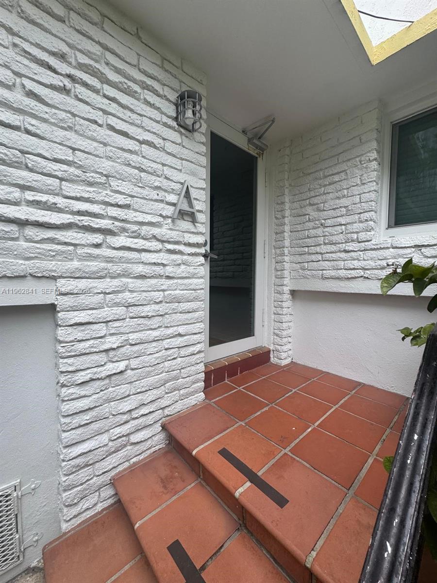 6941 Bay Drive, Unit A1 Miami Beach, FL 33141 - Photo 2 of 10 a view of a tennis court with wooden floor