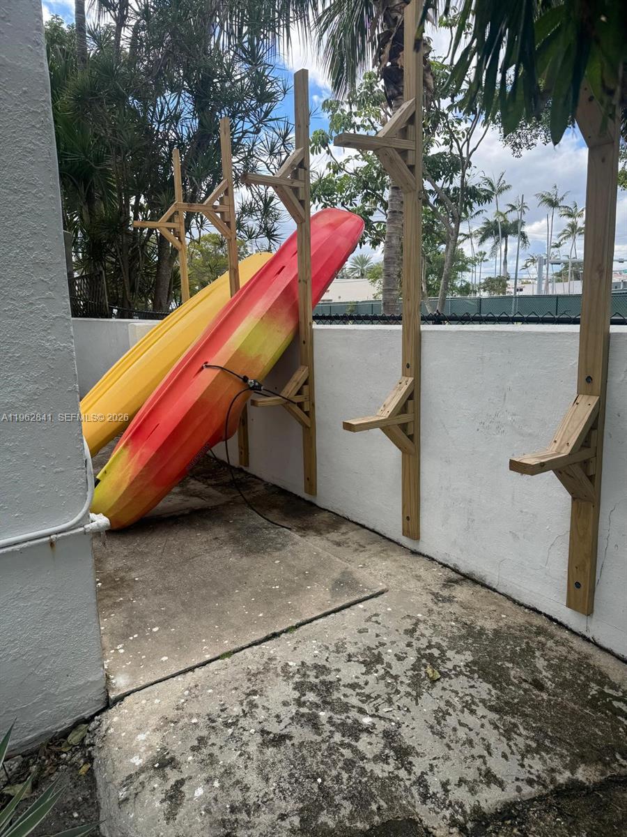 6941 Bay Drive, Unit A1 Miami Beach, FL 33141 - Photo 10 of 10 a backyard of a house with table and chairs