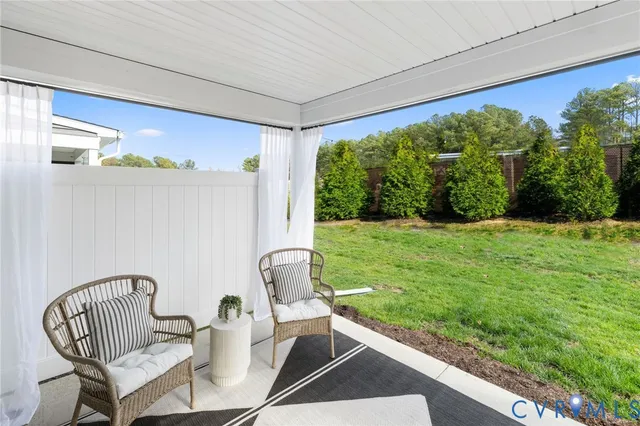 a view of yard from deck with patio
