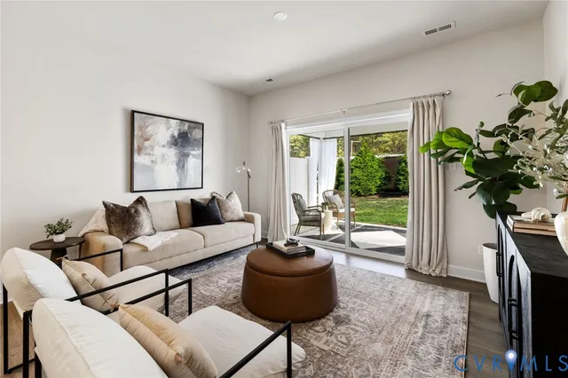 a living room with furniture and a potted plant