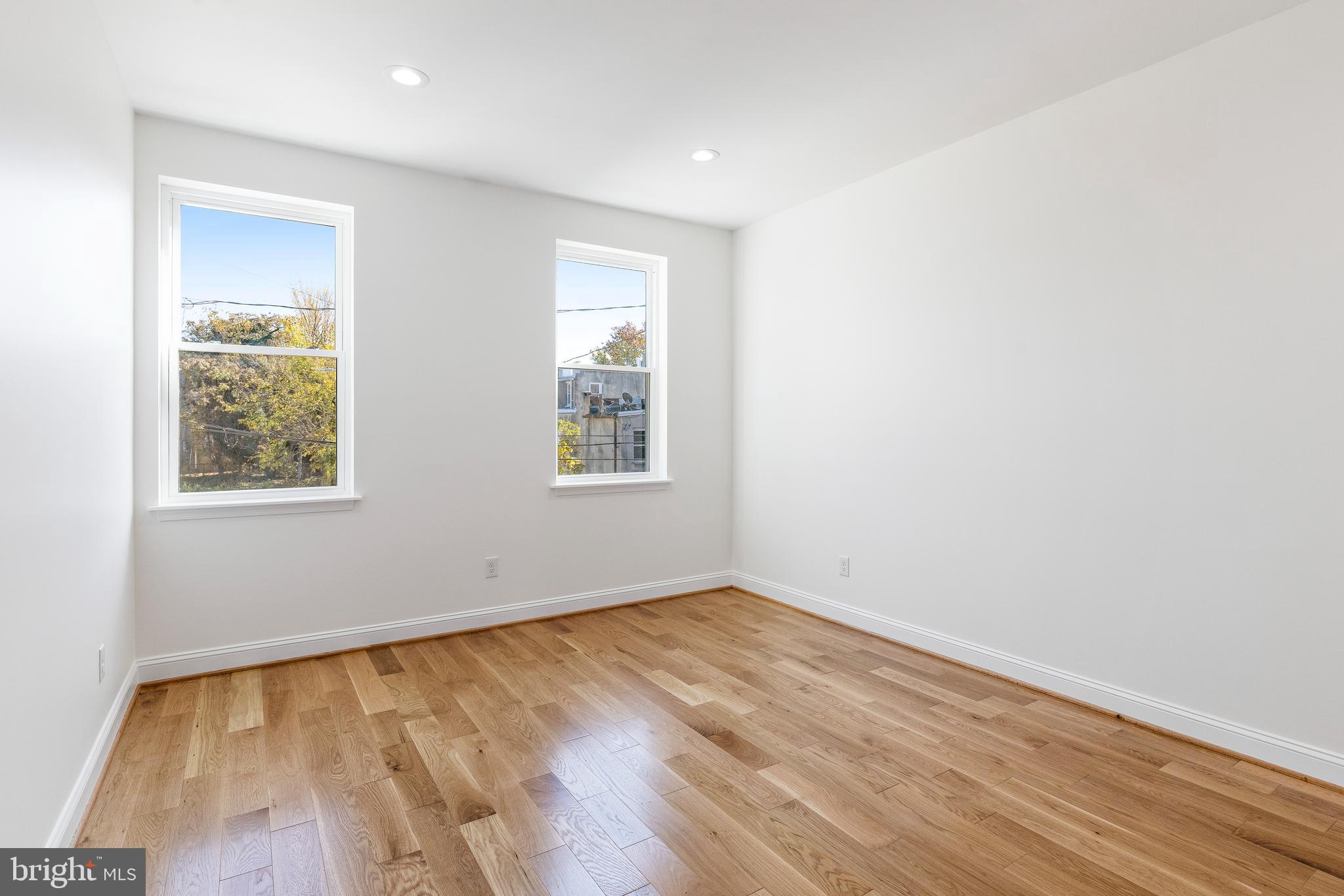 934 Harlem Avenue Baltimore, MD 21217 - Photo 12 of 28 an empty room with wooden floor and windows