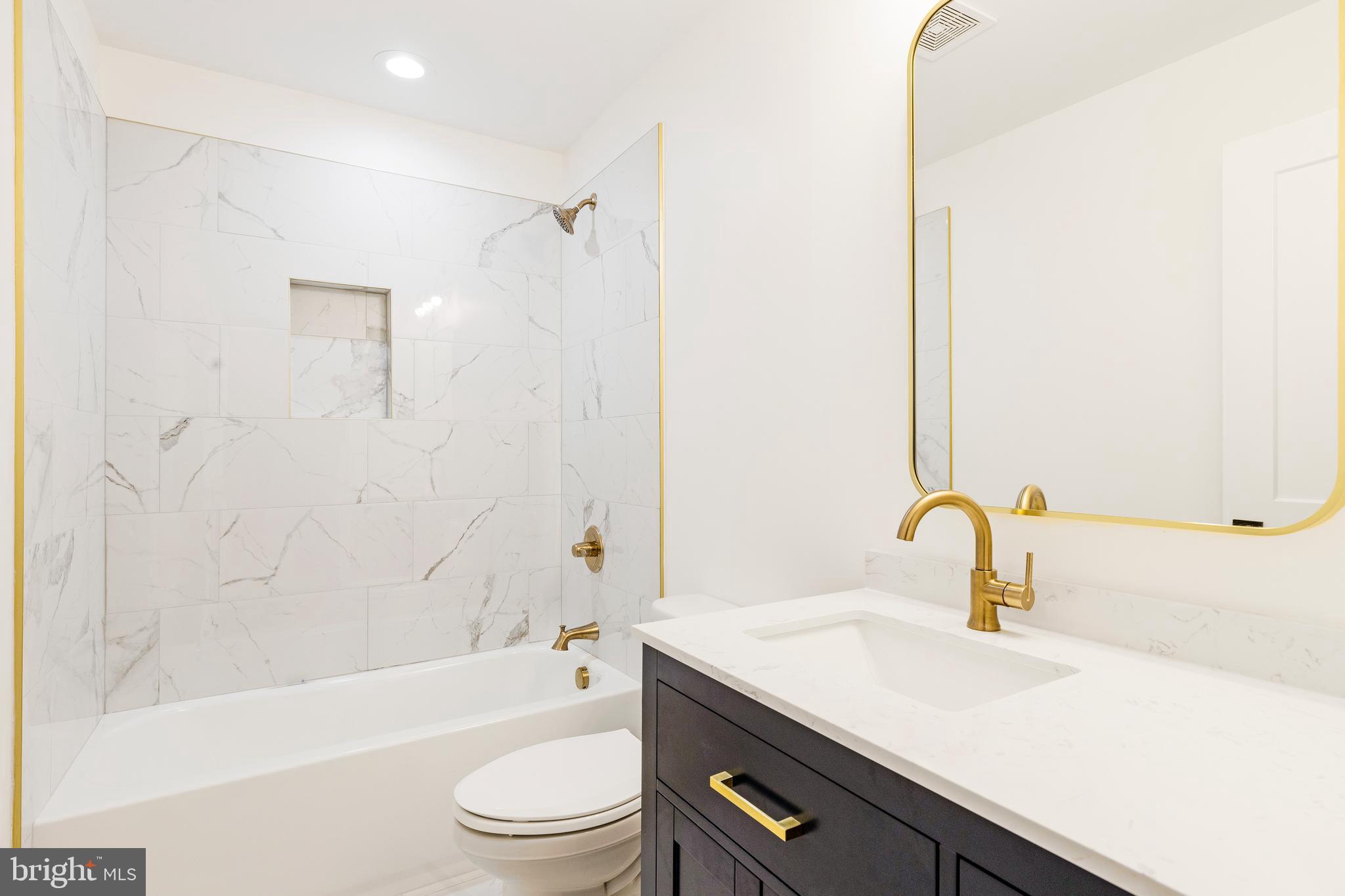 934 Harlem Avenue Baltimore, MD 21217 - Photo 14 of 28 a bathroom with a sink a toilet and a bathtub