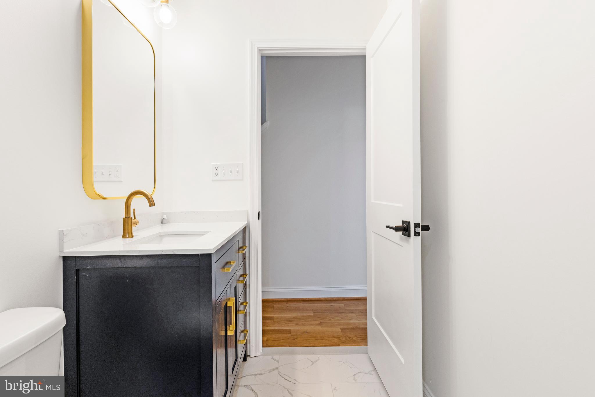 934 Harlem Avenue Baltimore, MD 21217 - Photo 15 of 28 a view of bathroom with a sink and mirror