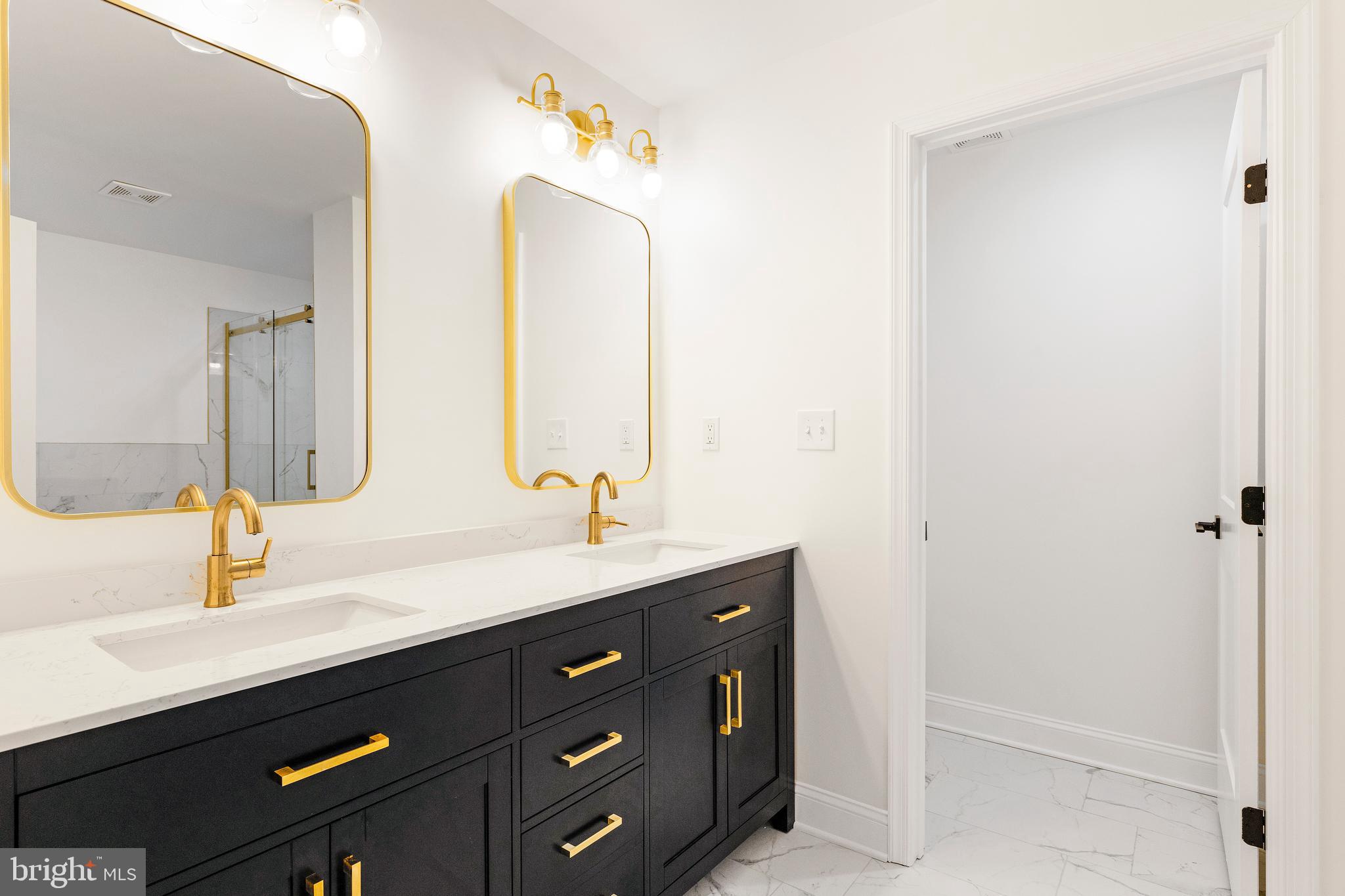 934 Harlem Avenue Baltimore, MD 21217 - Photo 17 of 28 a bathroom with a double vanity sink and a mirror