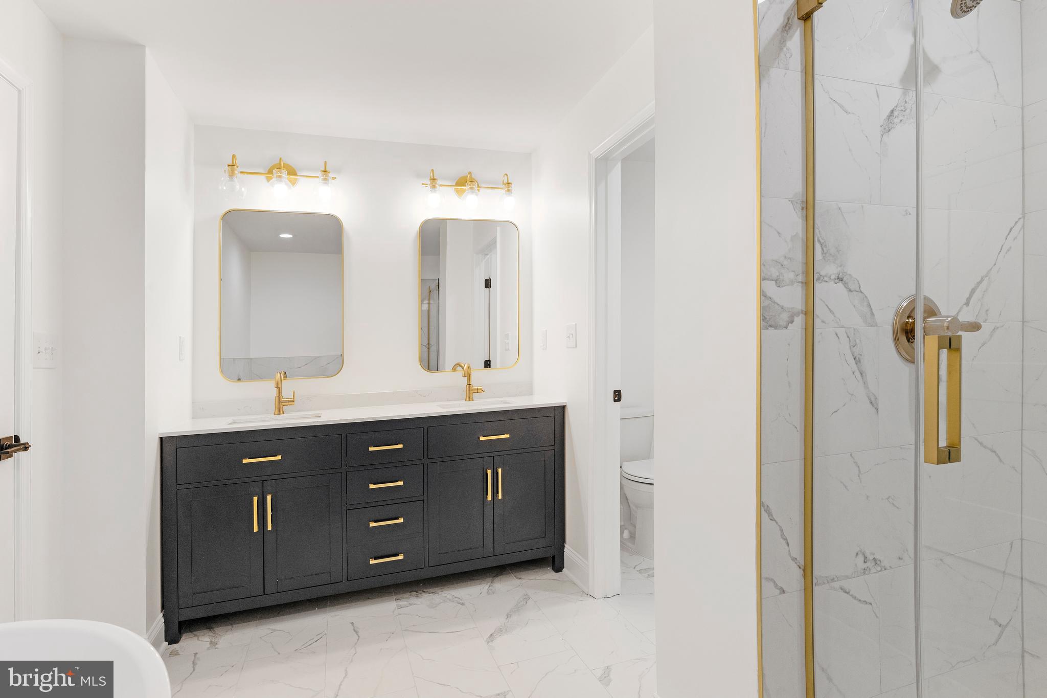 934 Harlem Avenue Baltimore, MD 21217 - Photo 19 of 28 a bathroom with a double vanity sink and mirror