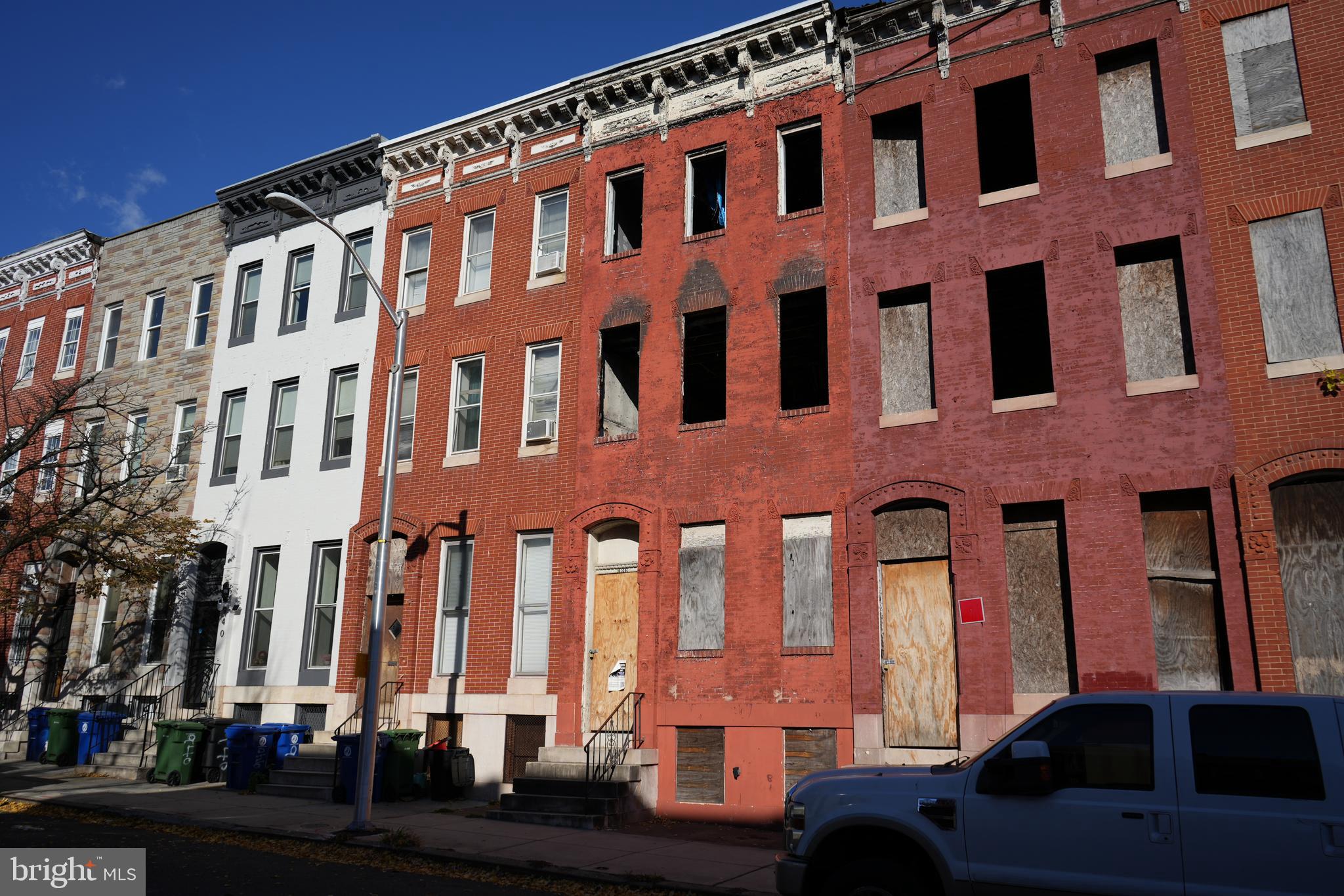 934 Harlem Avenue Baltimore, MD 21217 - Photo 2 of 28 a front view of a building with lot of cars parked