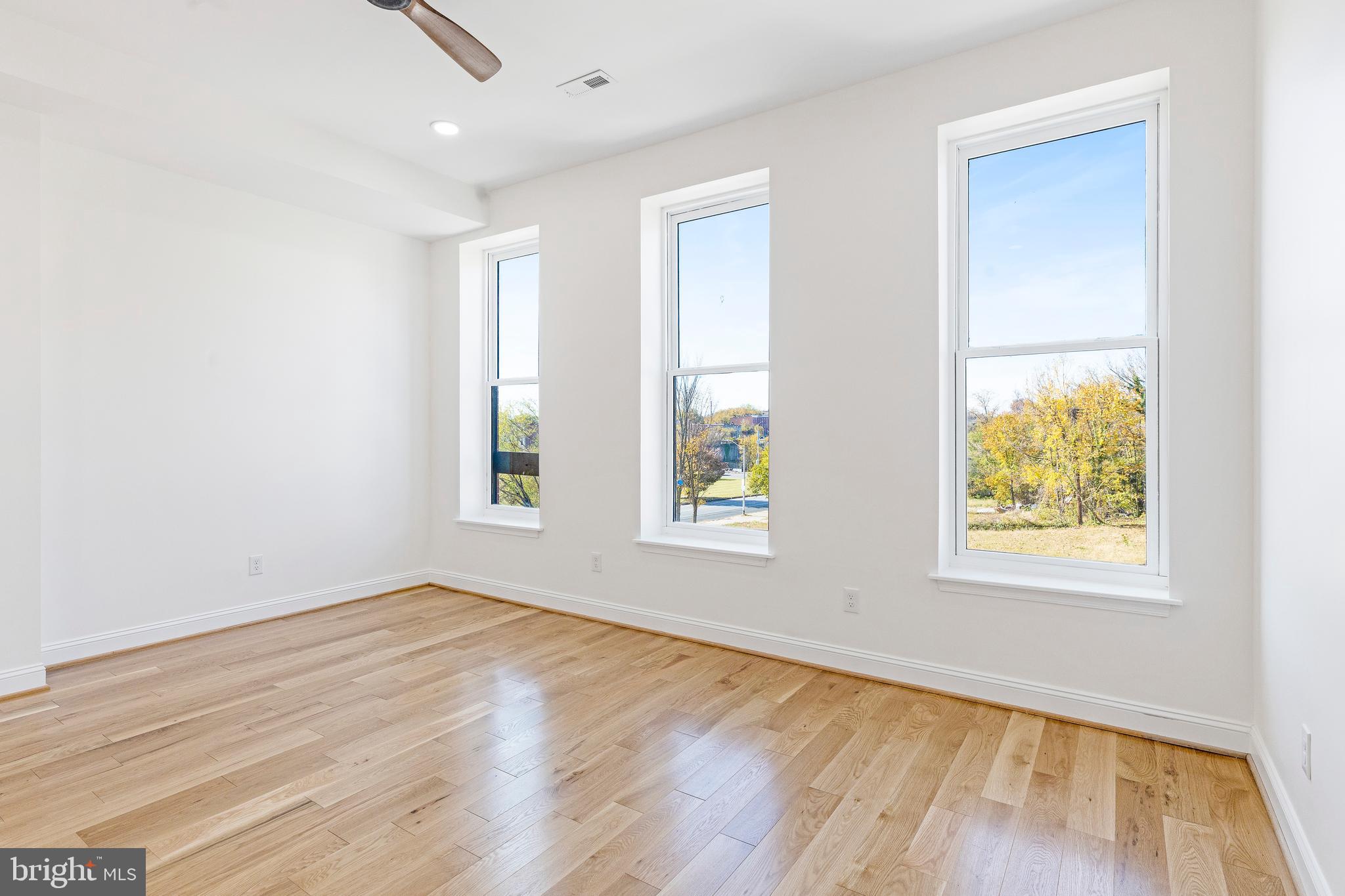 934 Harlem Avenue Baltimore, MD 21217 - Photo 23 of 28 an empty room with wooden floor and windows