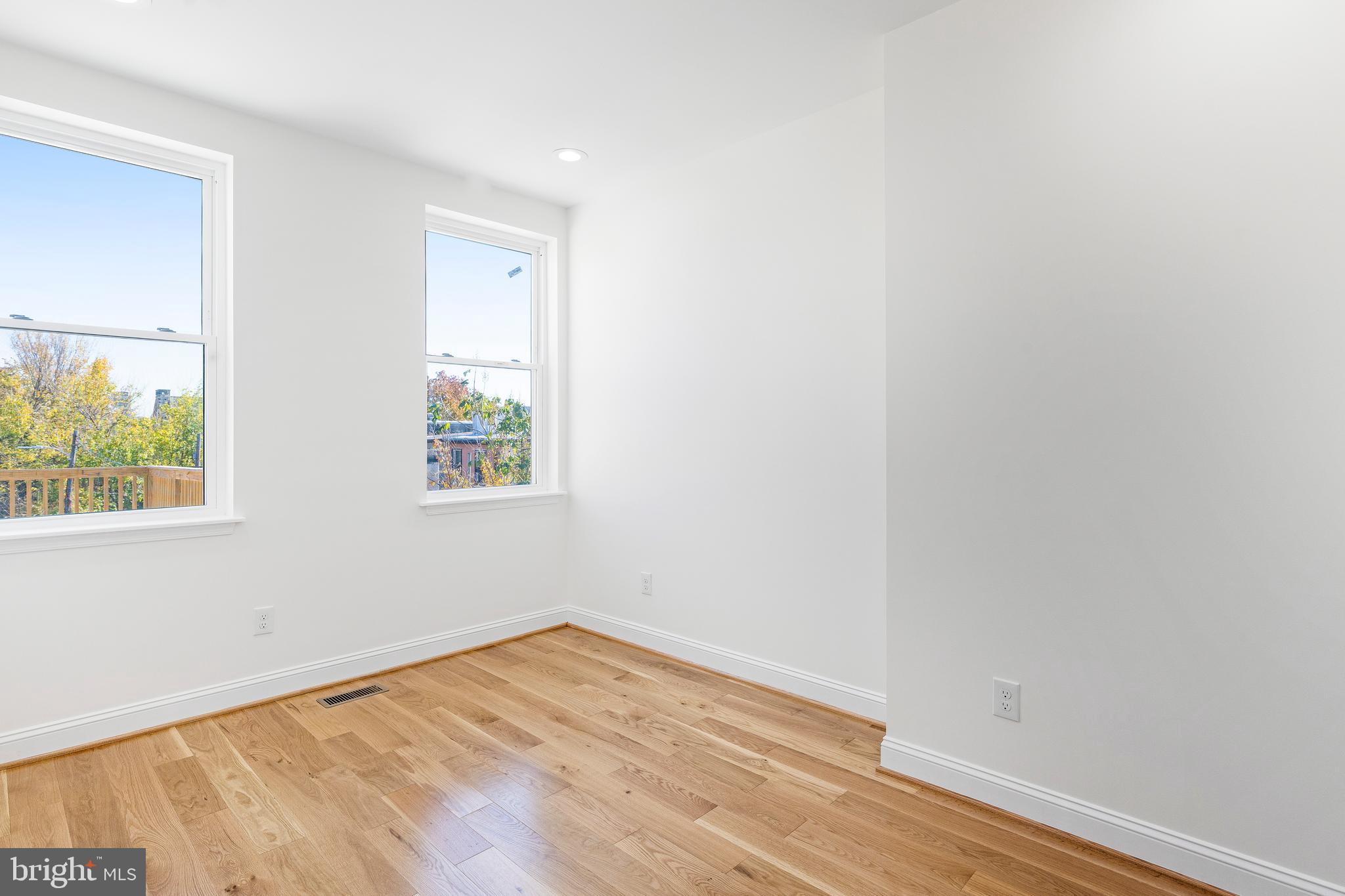 934 Harlem Avenue Baltimore, MD 21217 - Photo 25 of 28 an empty room with wooden floor and windows