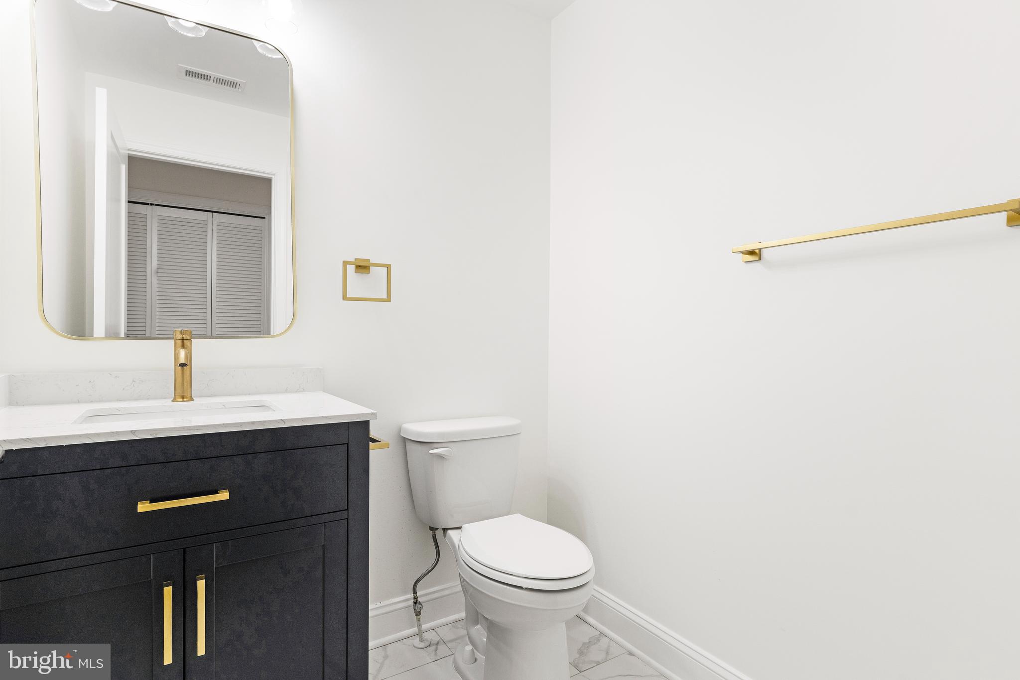 934 Harlem Avenue Baltimore, MD 21217 - Photo 6 of 28 a bathroom with a toilet a sink and mirror