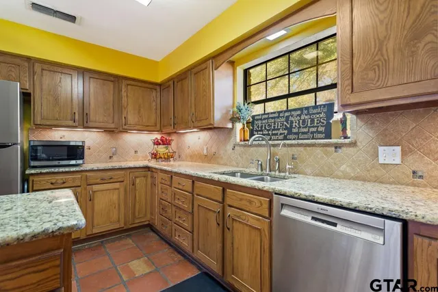 a kitchen with granite countertop sink cabinets and window