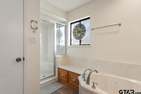 a bathroom with a bathtub and shower
