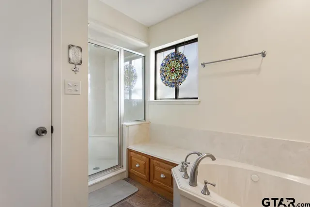 a bathroom with a bathtub and shower