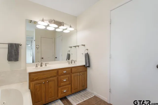 a bathroom with a double vanity sink and a mirror