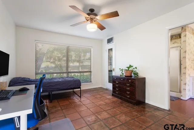 a bedroom with a bed and a window