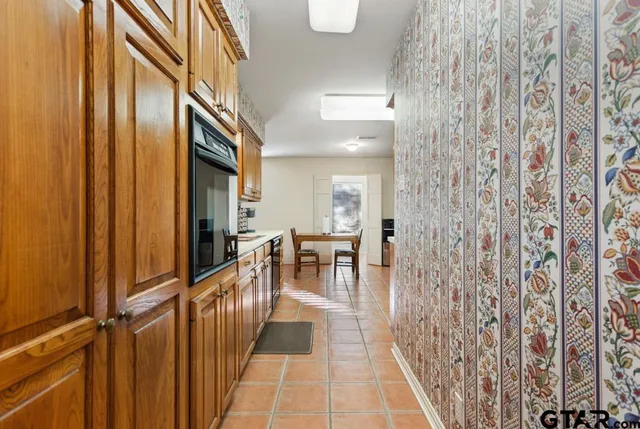 a hallway with table and chairs