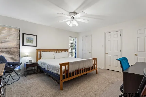 a spacious bedroom with a bed and a chandelier