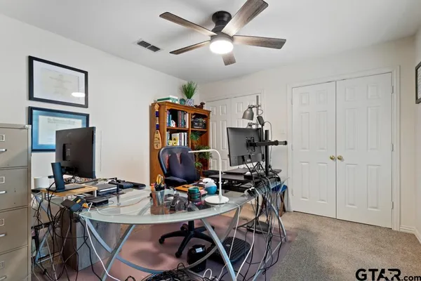 a view of a workspace with furniture and gym equipment