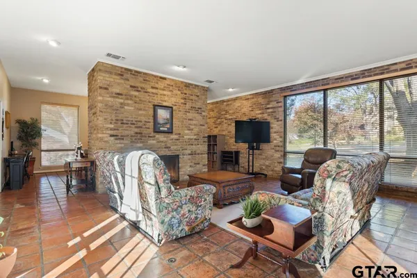 a living room with fireplace furniture and a flat screen tv
