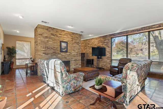a living room with fireplace furniture and a flat screen tv
