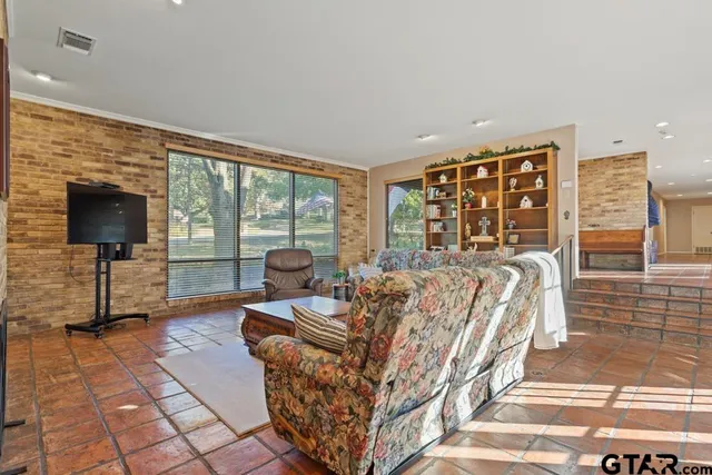 a living room with furniture and a floor to ceiling window
