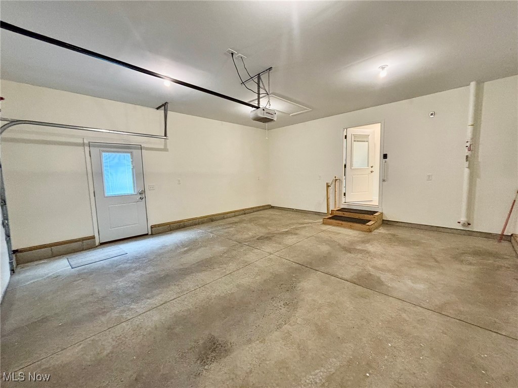 1132 Hummingbird Way Findlay, OH 45840 - Photo 26 of 28 Garage with a garage door opener and baseboards