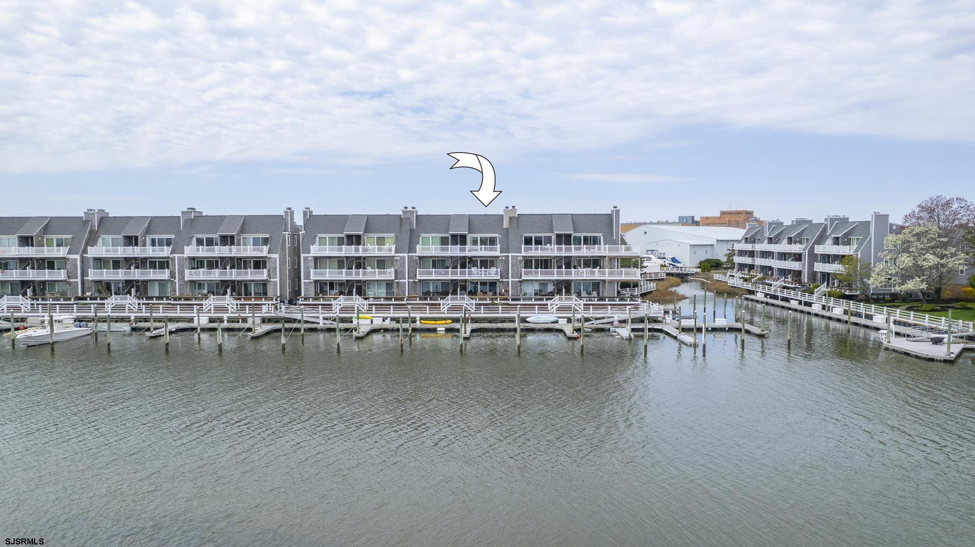 1608 Harbour Cove, Unit 1608 Somers Point, NJ 08244 - Photo 1 of 75 a view of a lake with building in front of it